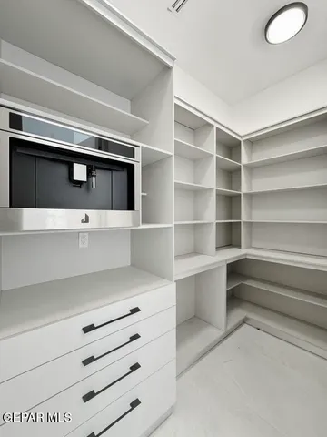 a kitchen with a sink and chandelier