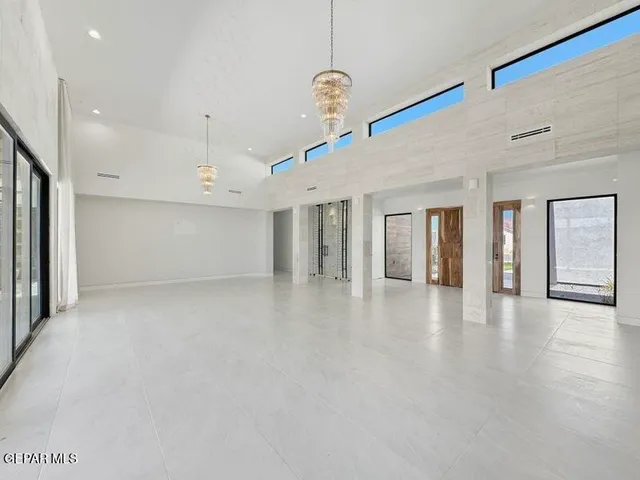a view of a hallway with white walls and windows