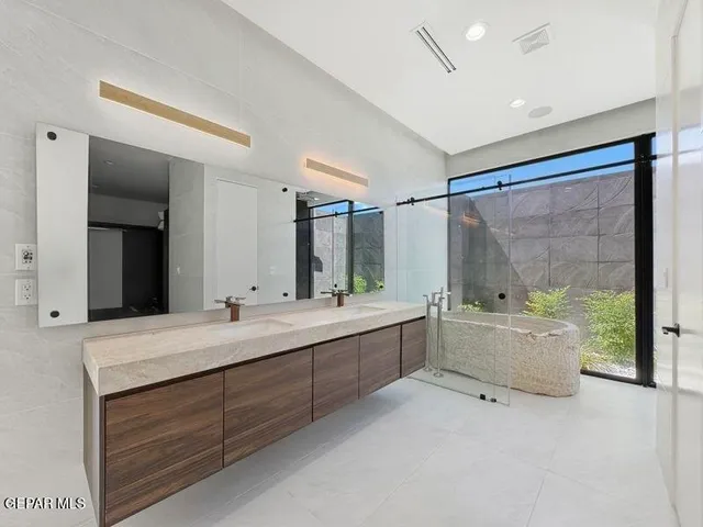 a view of an empty room with a fireplace and cabinet