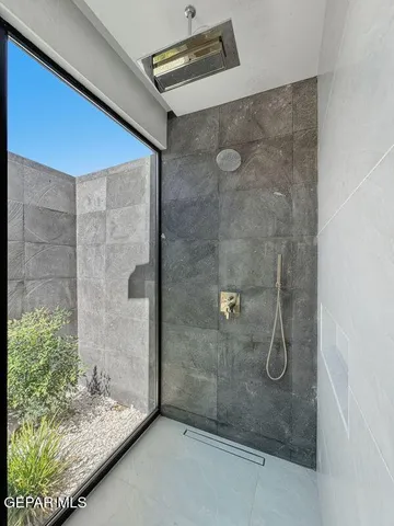 an empty room with ceiling fan and window