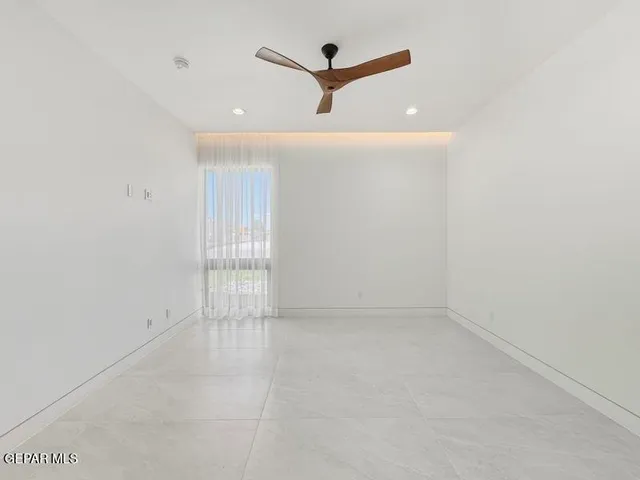 a bedroom with a bed and a ceiling fan