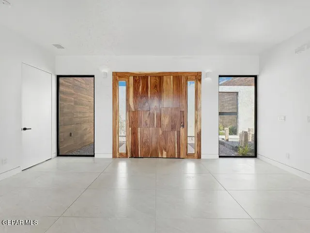 a kitchen with stainless steel appliances granite countertop a sink a stove and a refrigerator
