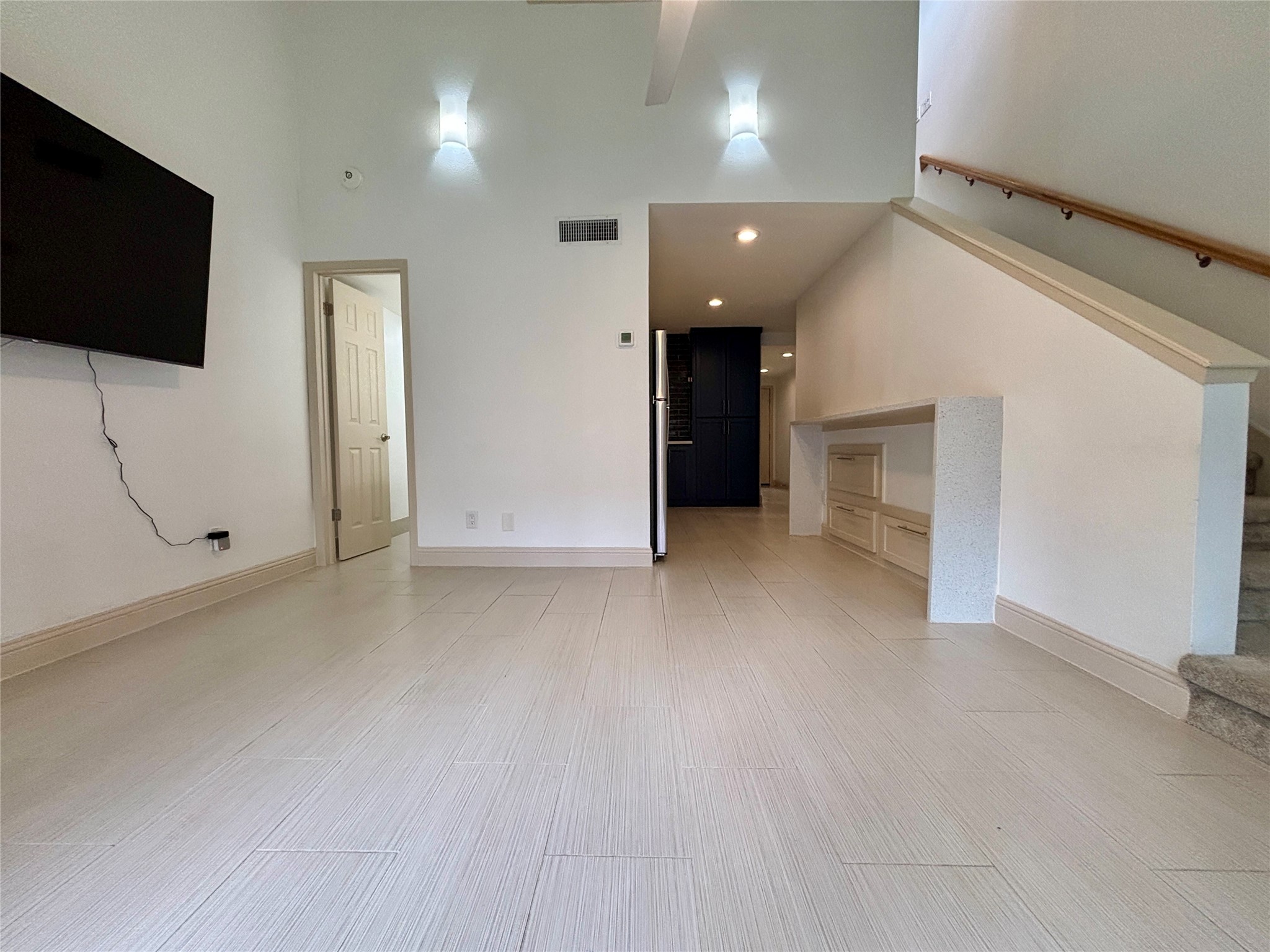 12900 Walden Road, Unit 508E Montgomery, TX 77356 - Photo 2 of 25 an empty room with flat screen tv and windows