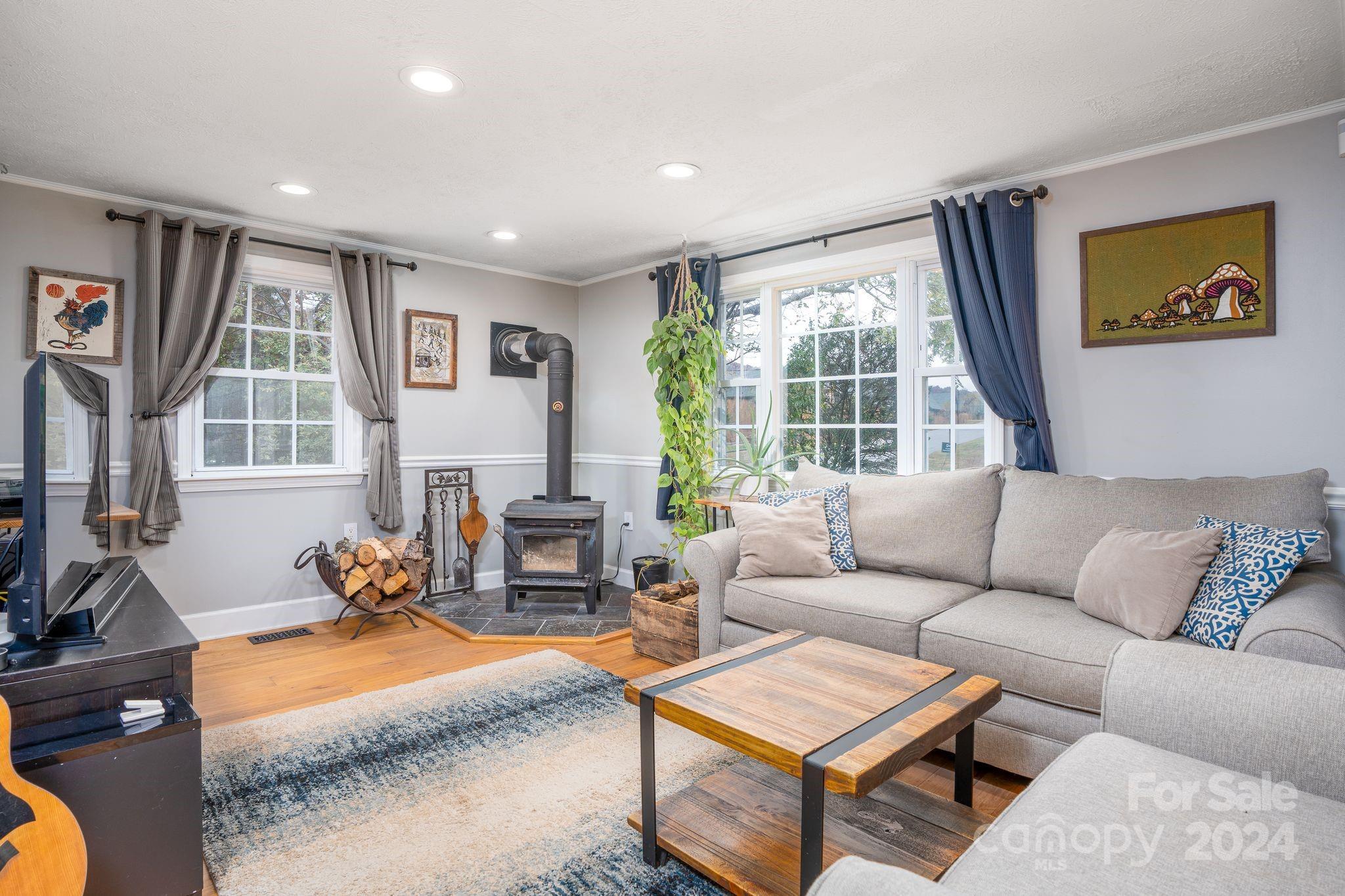 307 Tabernacle Road Black Mountain, NC 28711 - Photo 5 of 27 a living room with furniture a fireplace and a large window
