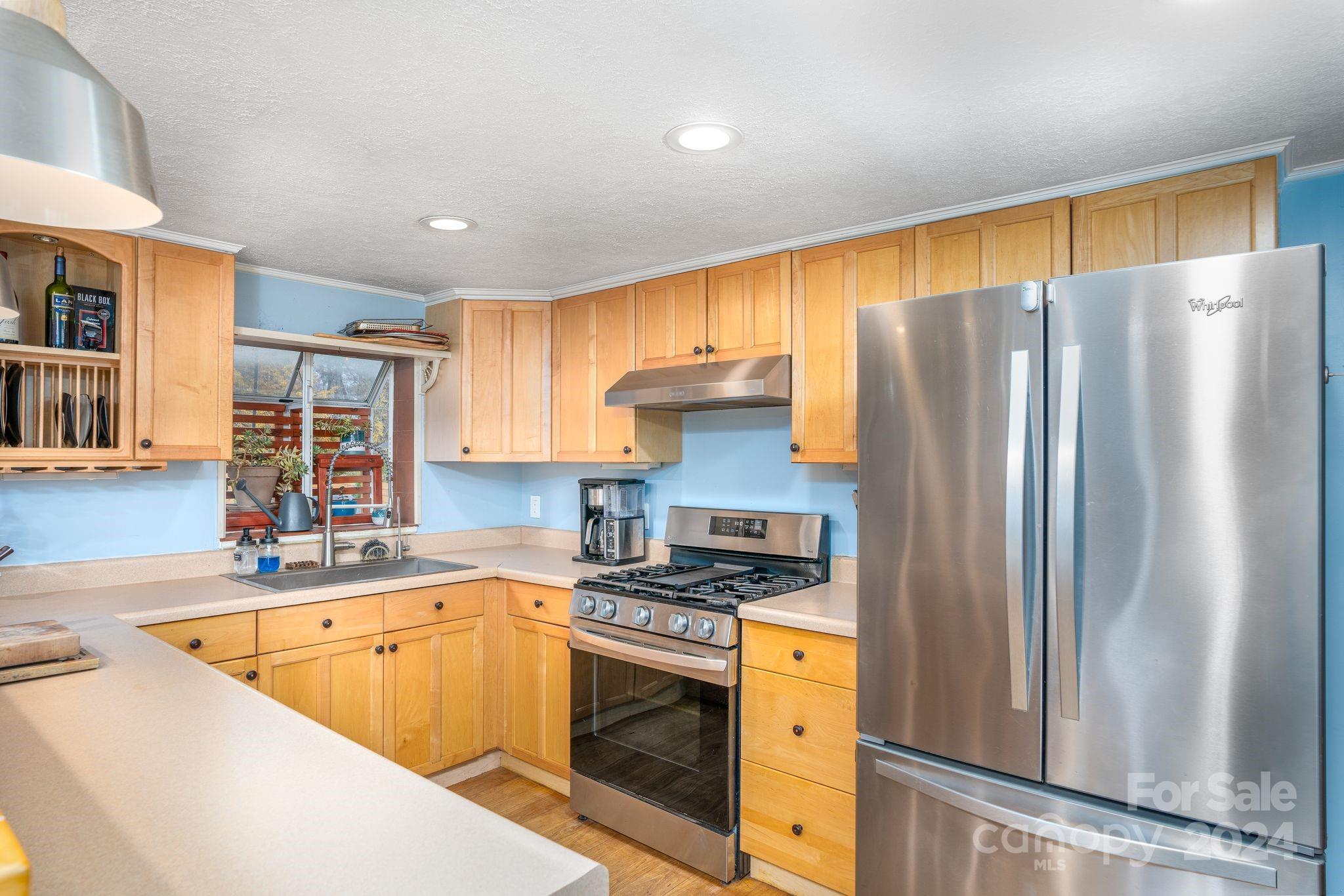 307 Tabernacle Road Black Mountain, NC 28711 - Photo 8 of 27 a kitchen that has a refrigerator a sink and white cabinets