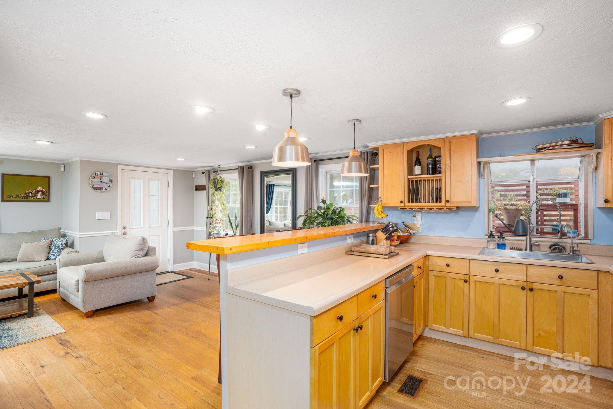 307 Tabernacle Road Black Mountain, NC 28711 - Photo 9 of 27 a view of a kitchen with kitchen island a sink and a large window