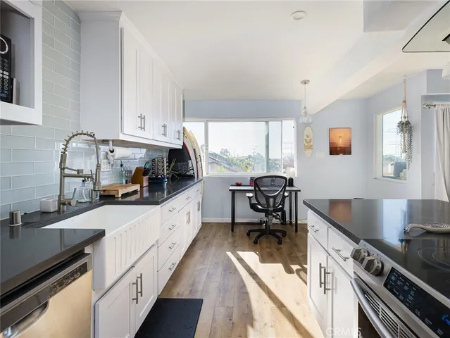 a kitchen with a sink appliances and a counter top space