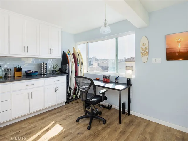 a view of a workspace with furniture and a window