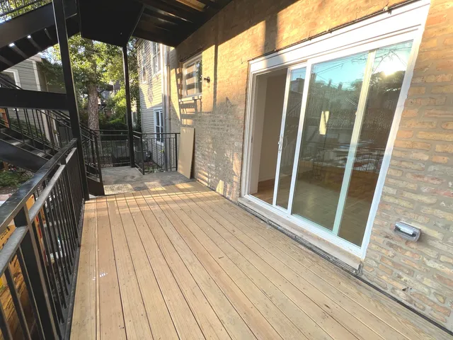 a view of balcony with wooden floor