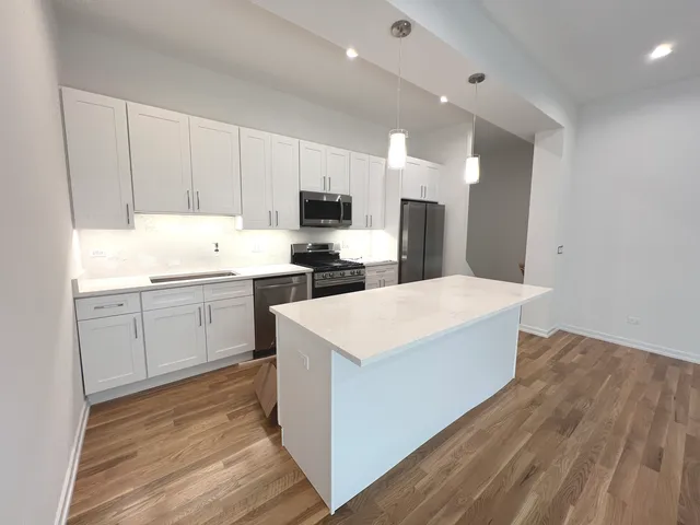 a view of a room with wooden floor and white walls