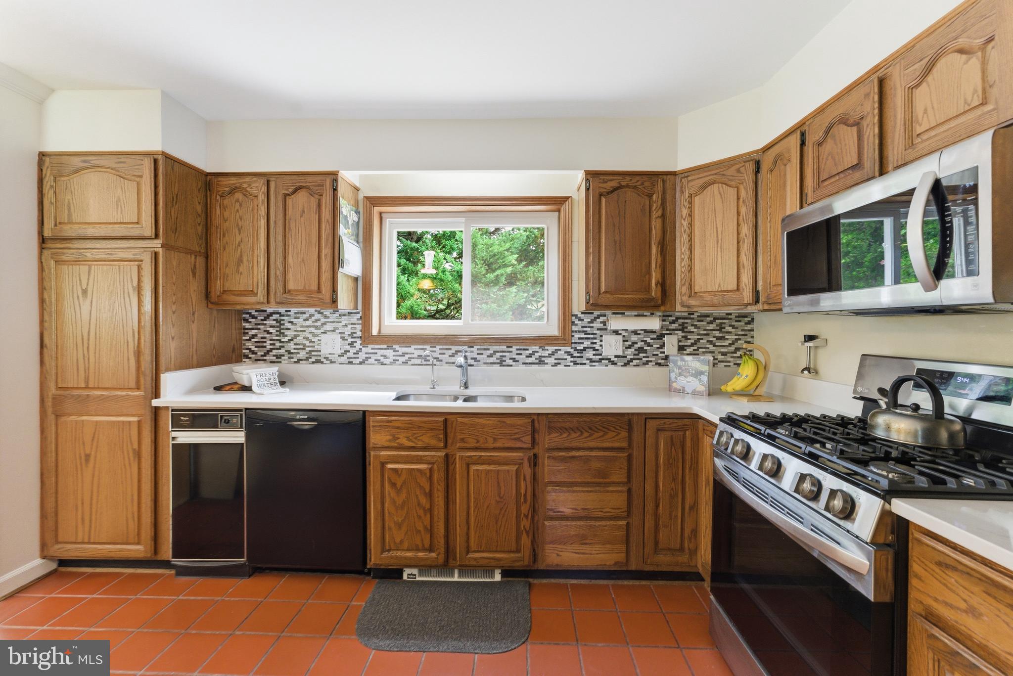 2100 Edgewater Parkway Silver Spring, MD 20903 - Photo 12 of 46 a kitchen with stainless steel appliances granite countertop a stove a sink dishwasher and a refrigerator