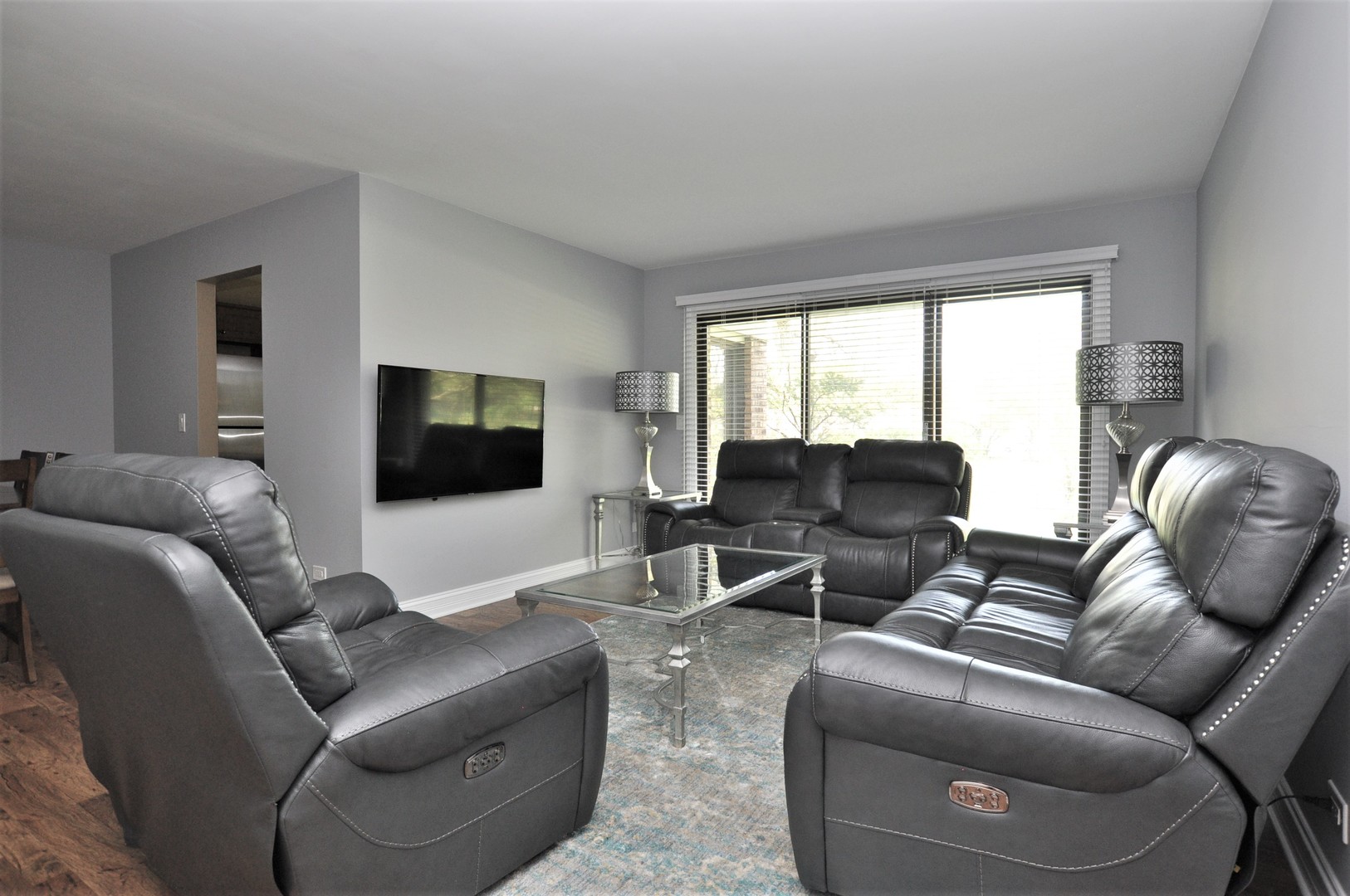 216 Deerpath Court, Unit D1 Schaumburg, IL 60193 - Photo 3 of 16 a living room with furniture and a flat screen tv