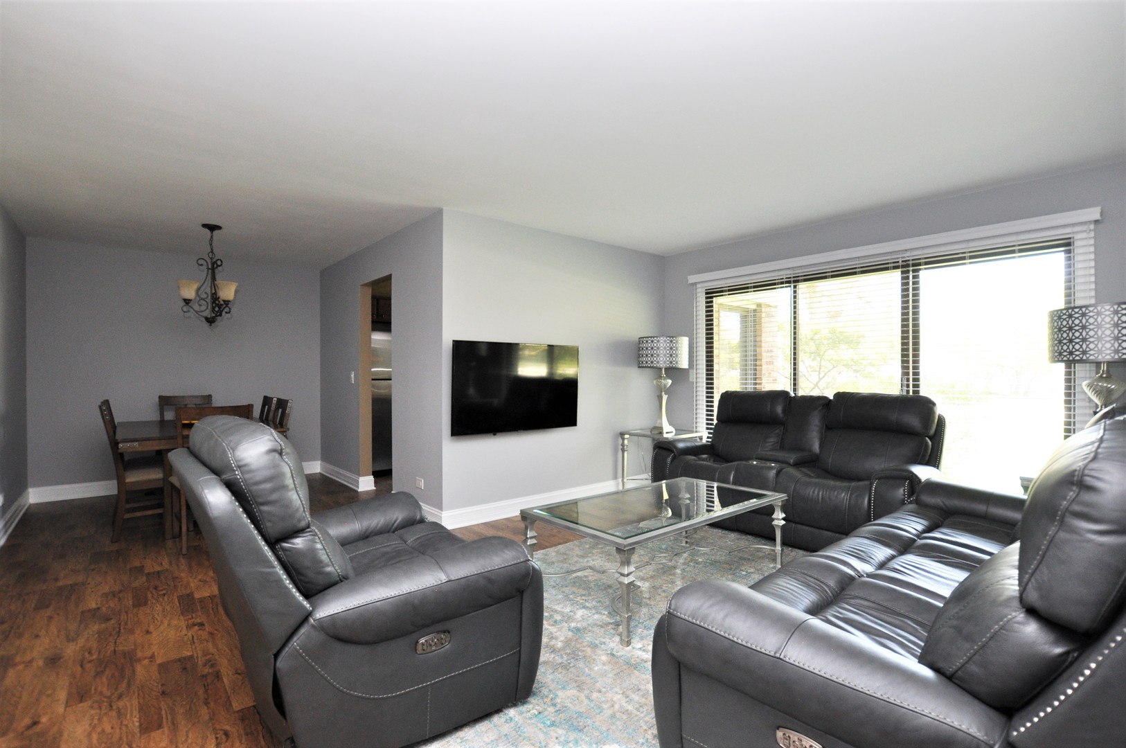 216 Deerpath Court, Unit D1 Schaumburg, IL 60193 - Photo 4 of 16 a living room with furniture and a flat screen tv