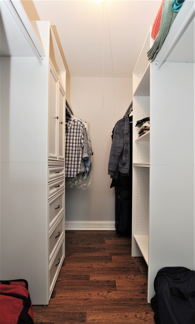 216 Deerpath Court, Unit D1 Schaumburg, IL 60193 - Photo 9 of 16 a view of walk in closet with clothes and shoes