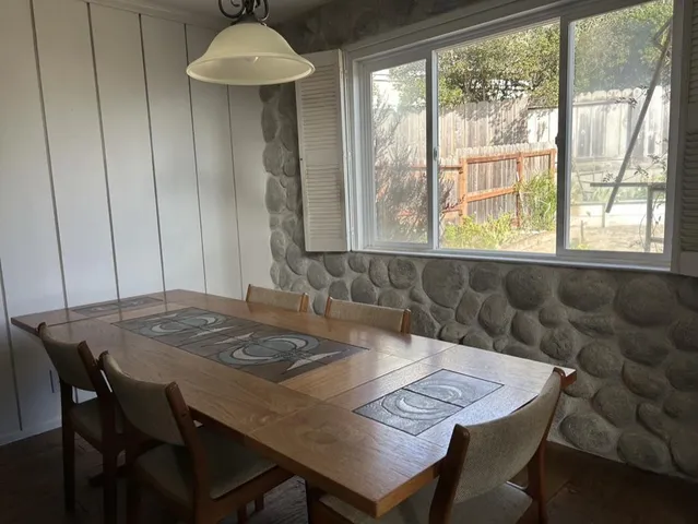 a kitchen with a table and chairs