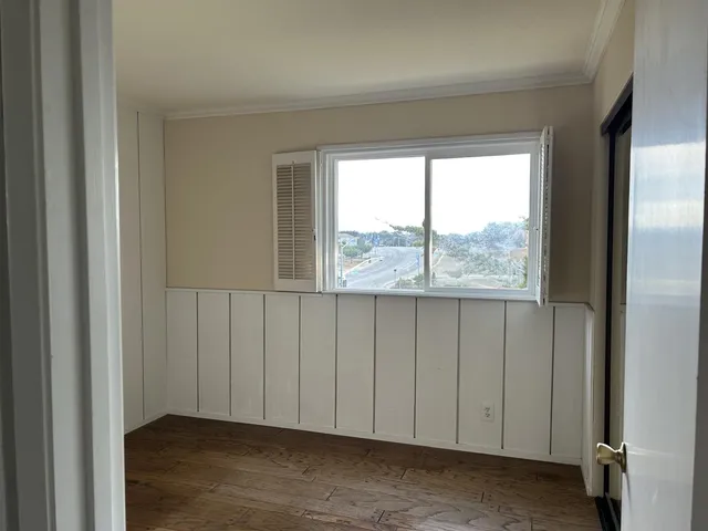 wooden floor in a hallway with a room