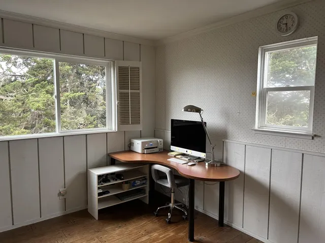 a backyard with wooden fence and a bench