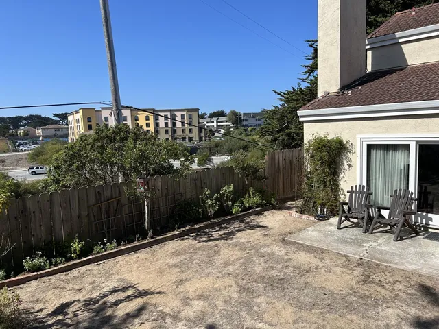 a backyard of a house with yard and outdoor seating