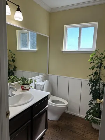 a bathroom with a sink a toilet and mirror