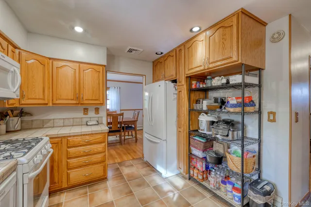 a kitchen with refrigerator and cabinets