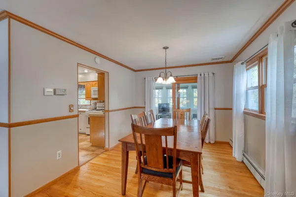 a view of a dining room with furniture window and wooden floor