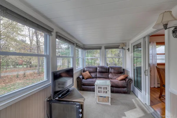 a living room with furniture and large windows
