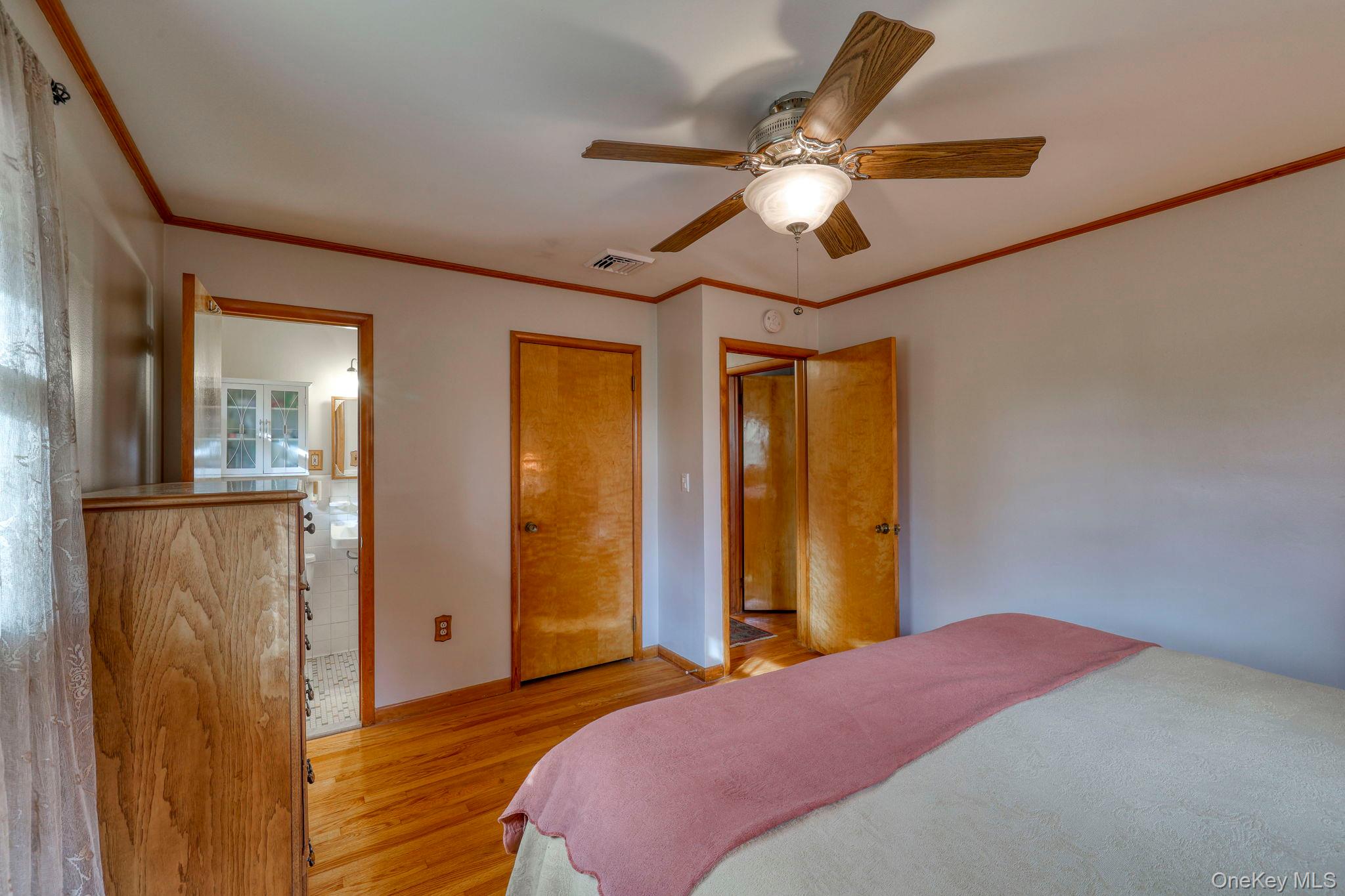 4 Irene Court Fishkill, NY 12524 - Photo 14 of 46 Bedroom featuring wood finished floors, ornamental molding, ceiling fan, and a closet