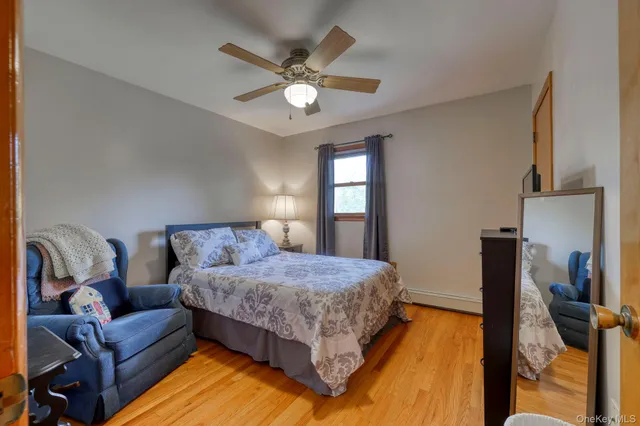 a bedroom with a bed couch and window