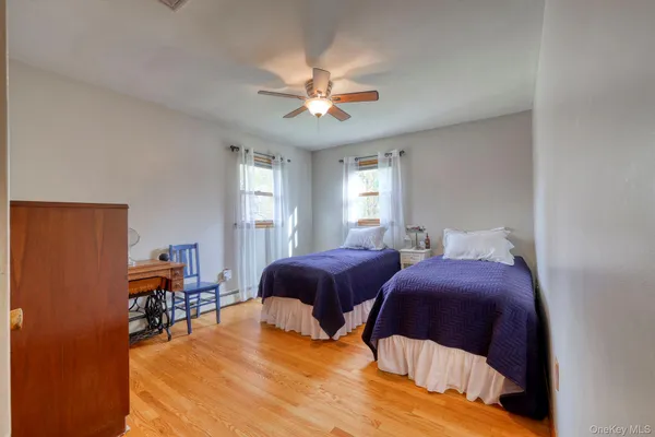 a bedroom with two beds and a chandelier