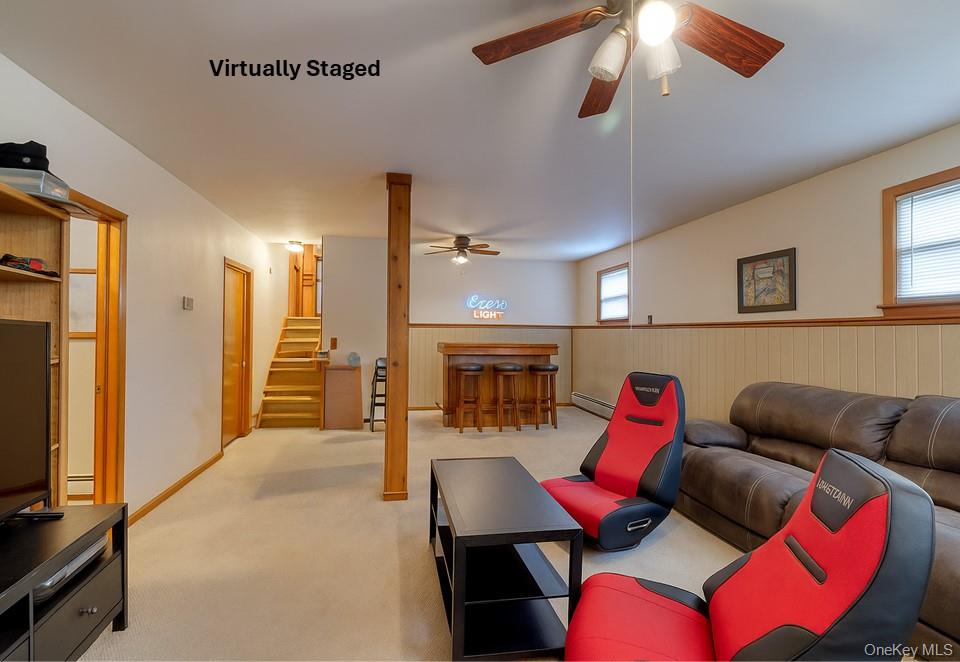 4 Irene Court Fishkill, NY 12524 - Photo 25 of 46 a living room with furniture a fireplace and a chandelier