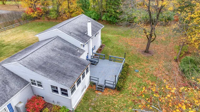 a view of a house with backyard and trees