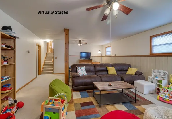 a living room with furniture a rug and a chandelier