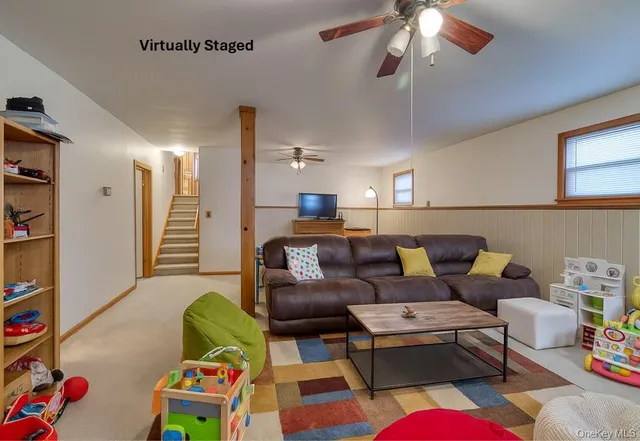 a living room with furniture a rug and a chandelier