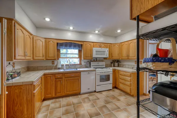 a kitchen with stainless steel appliances granite countertop sink stove and cabinets