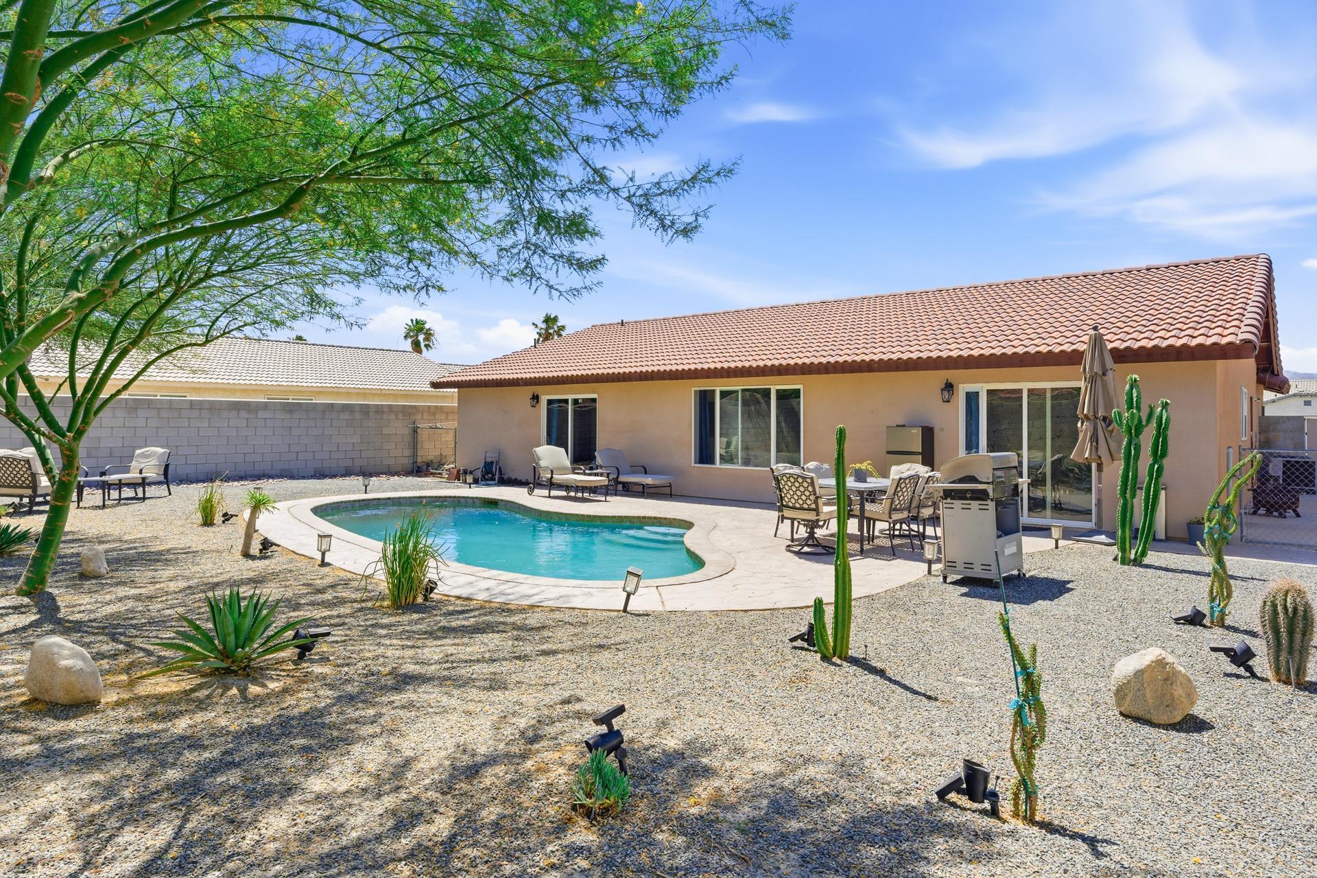 67220 Quijo Road Cathedral City, CA 92234 - Photo 25 of 26 a view of a house with backyard and sitting area