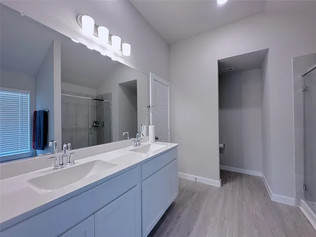 a bathroom with a double vanity sink and a mirror