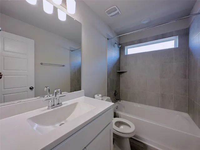 a bathroom with a sink a toilet and a bathtub