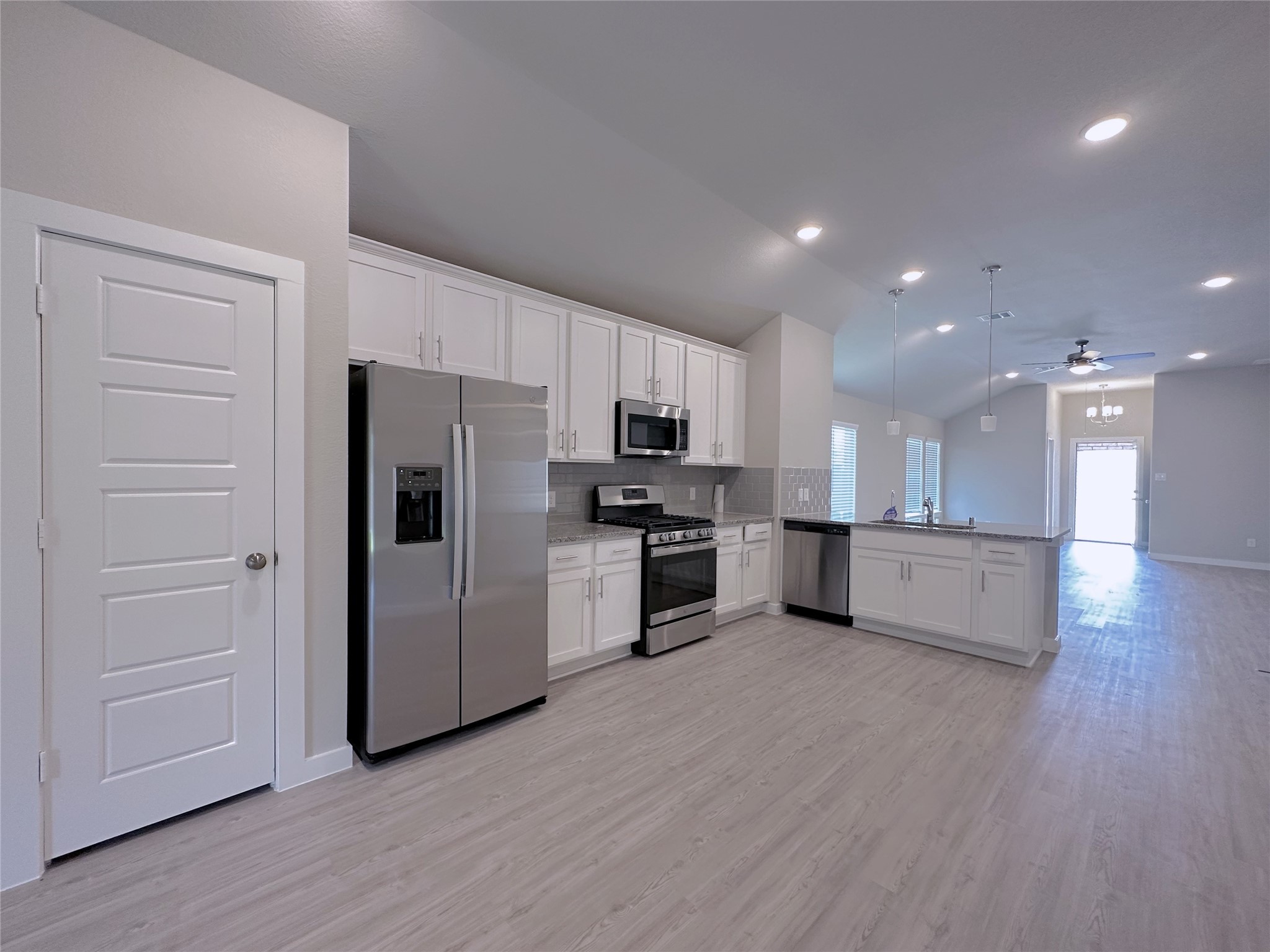 5835 Sunrise Btm Lane Fulshear, TX 77441 - Photo 2 of 22 a kitchen with a refrigerator and a stove top oven