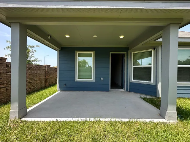 a view of entrance gate of a house with a garden
