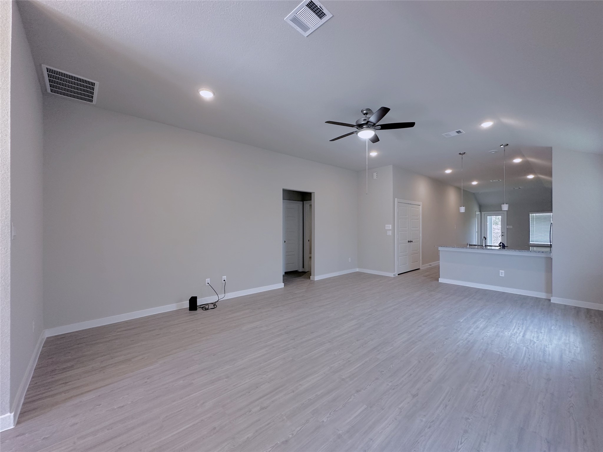 5835 Sunrise Btm Lane Fulshear, TX 77441 - Photo 6 of 22 an empty room with a ceiling fan and wooden floor
