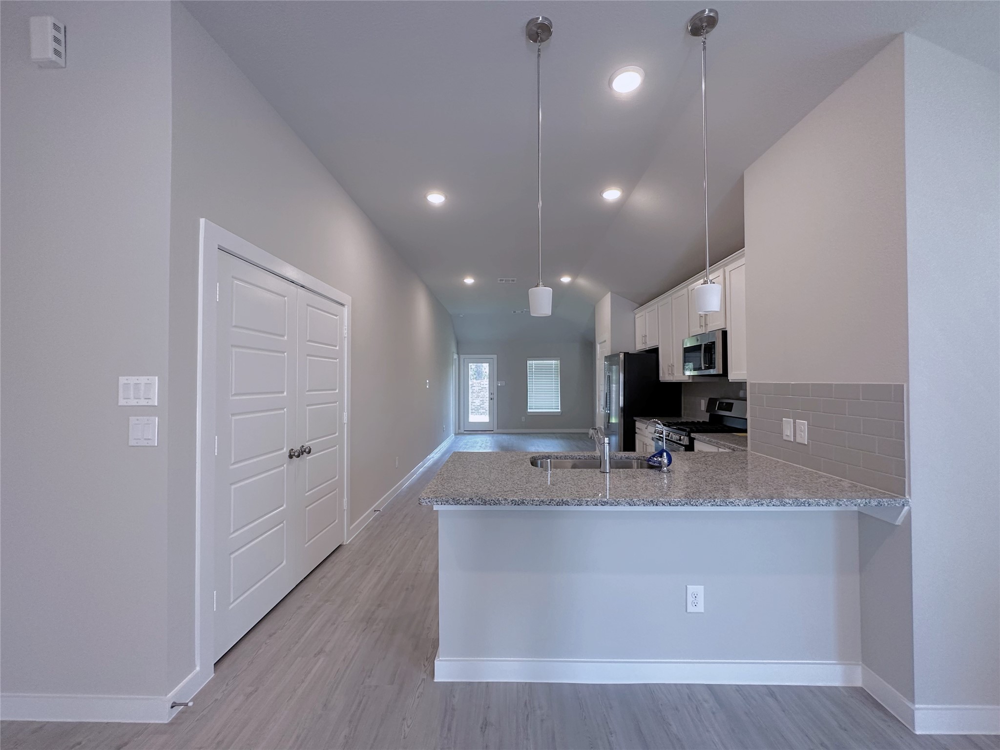 5835 Sunrise Btm Lane Fulshear, TX 77441 - Photo 7 of 22 a kitchen with kitchen island a sink stainless steel appliances and cabinets