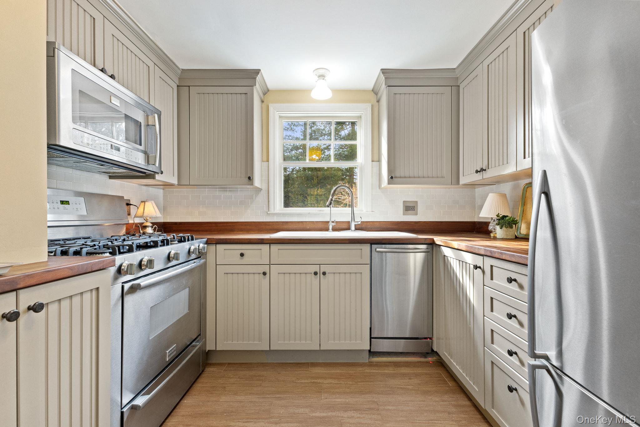 8 South Bedford Road Pound Ridge, NY 10576 - Photo 14 of 32 a kitchen with stainless steel appliances granite countertop a stove and a sink