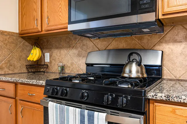 a stove top oven sitting inside of a kitchen