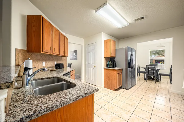 a kitchen with a sink a stove and cabinets