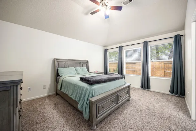 a bedroom with a bed and window