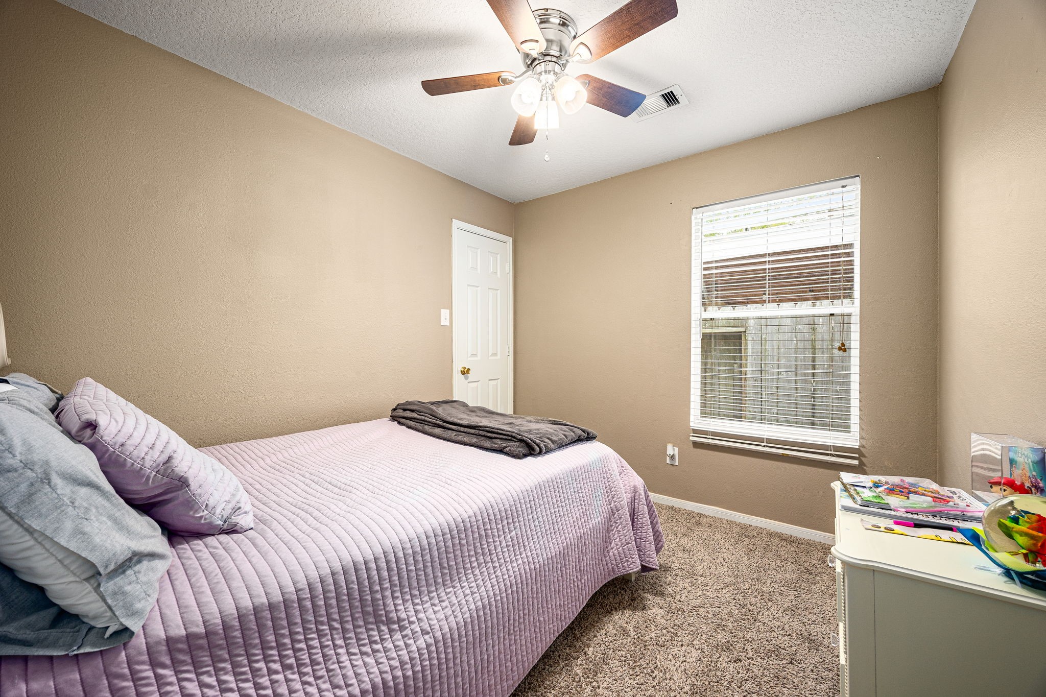 16945 Scenic Knoll Conroe, TX 77385 - Photo 26 of 39 a bedroom with a bed and a chandelier