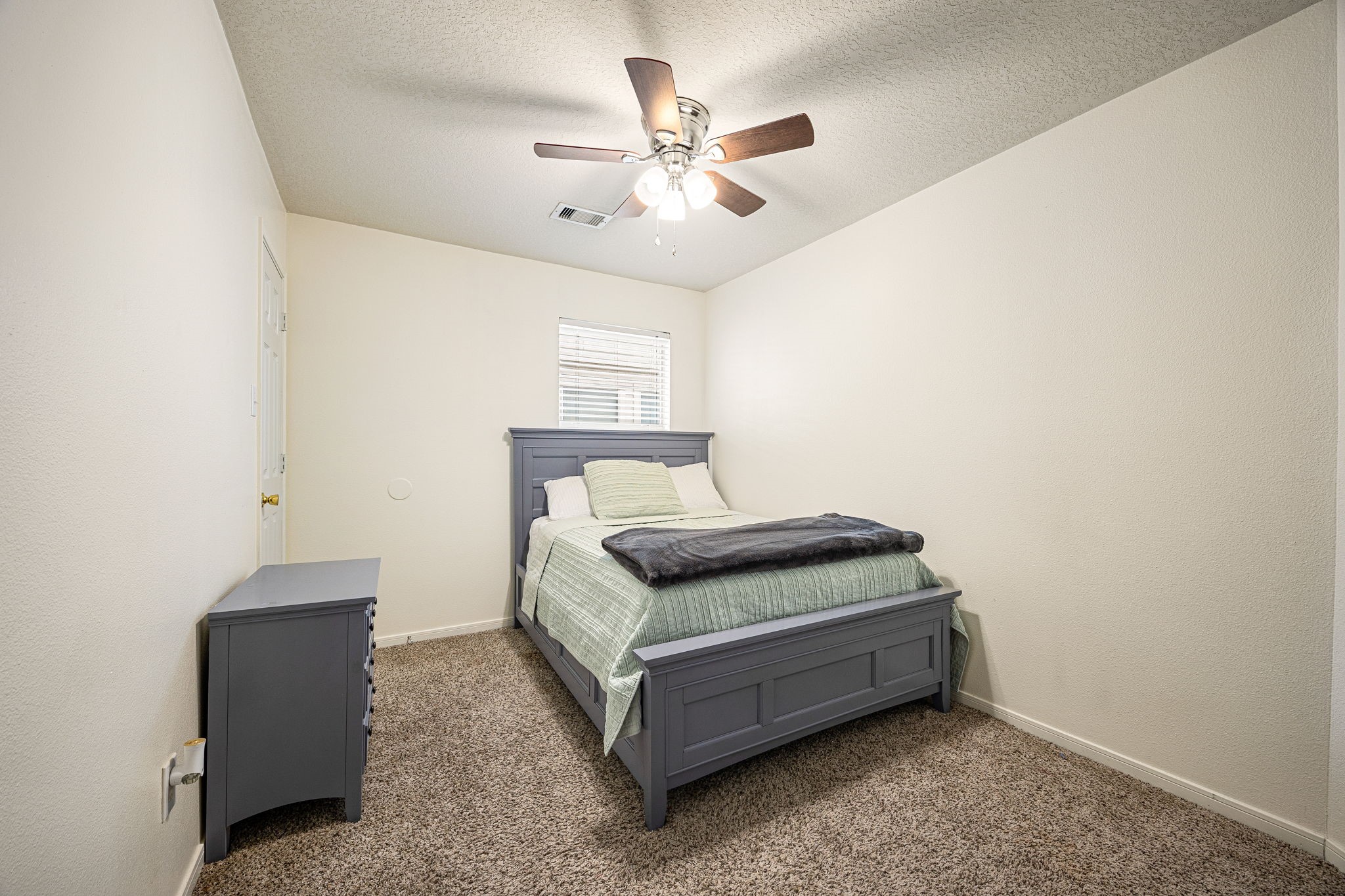 16945 Scenic Knoll Conroe, TX 77385 - Photo 29 of 39 a bedroom with a bed and window