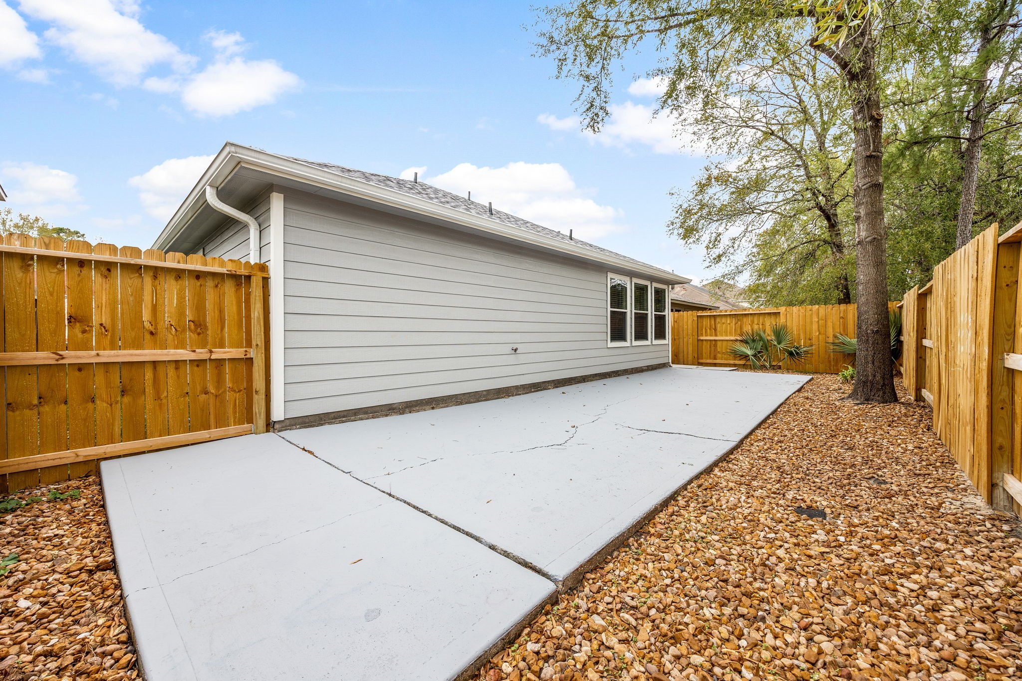 16945 Scenic Knoll Conroe, TX 77385 - Photo 36 of 39 a backyard of a house with wooden fence