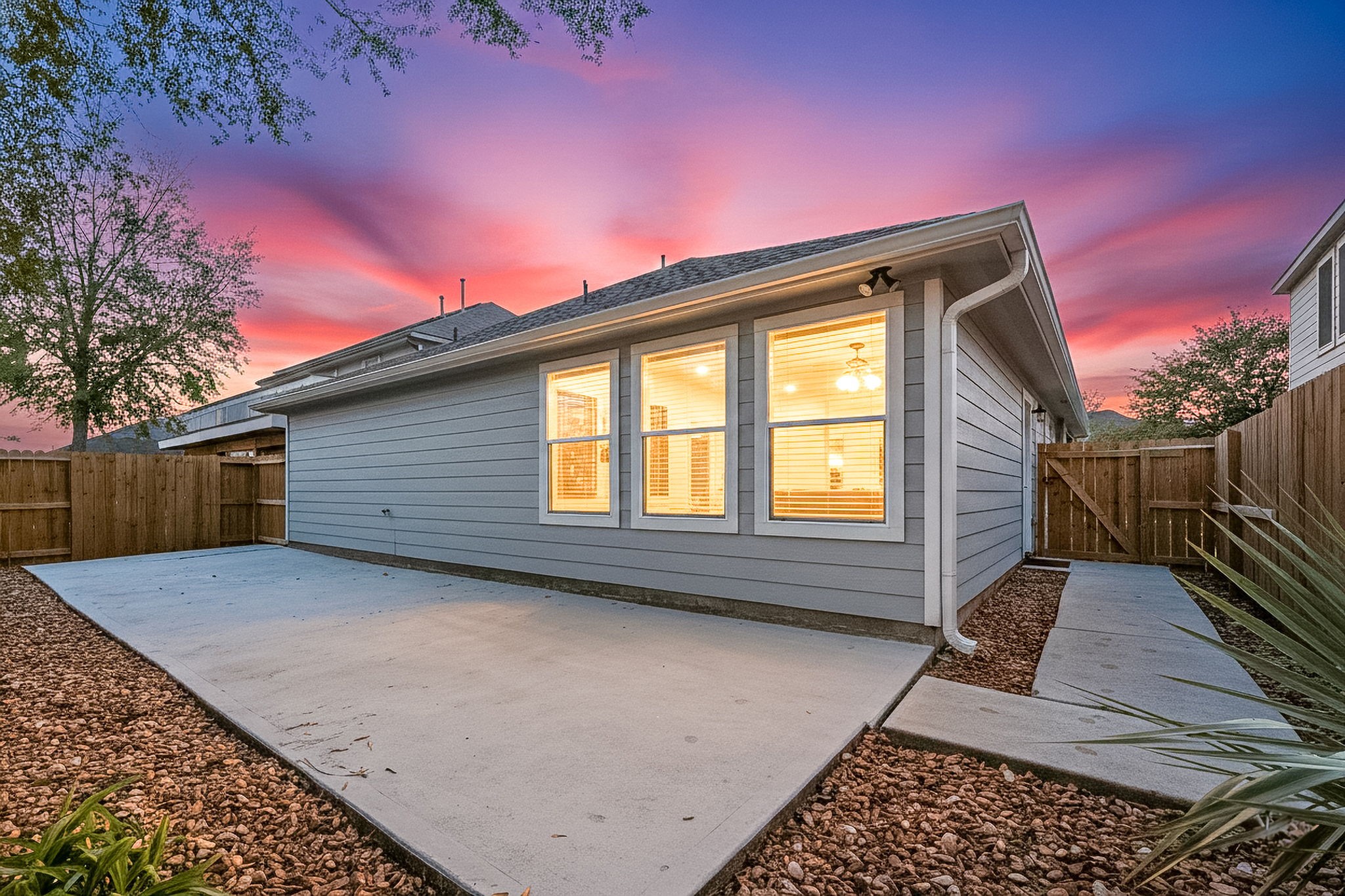 16945 Scenic Knoll Conroe, TX 77385 - Photo 38 of 39 a backyard of a house with wooden floor and outdoor seating