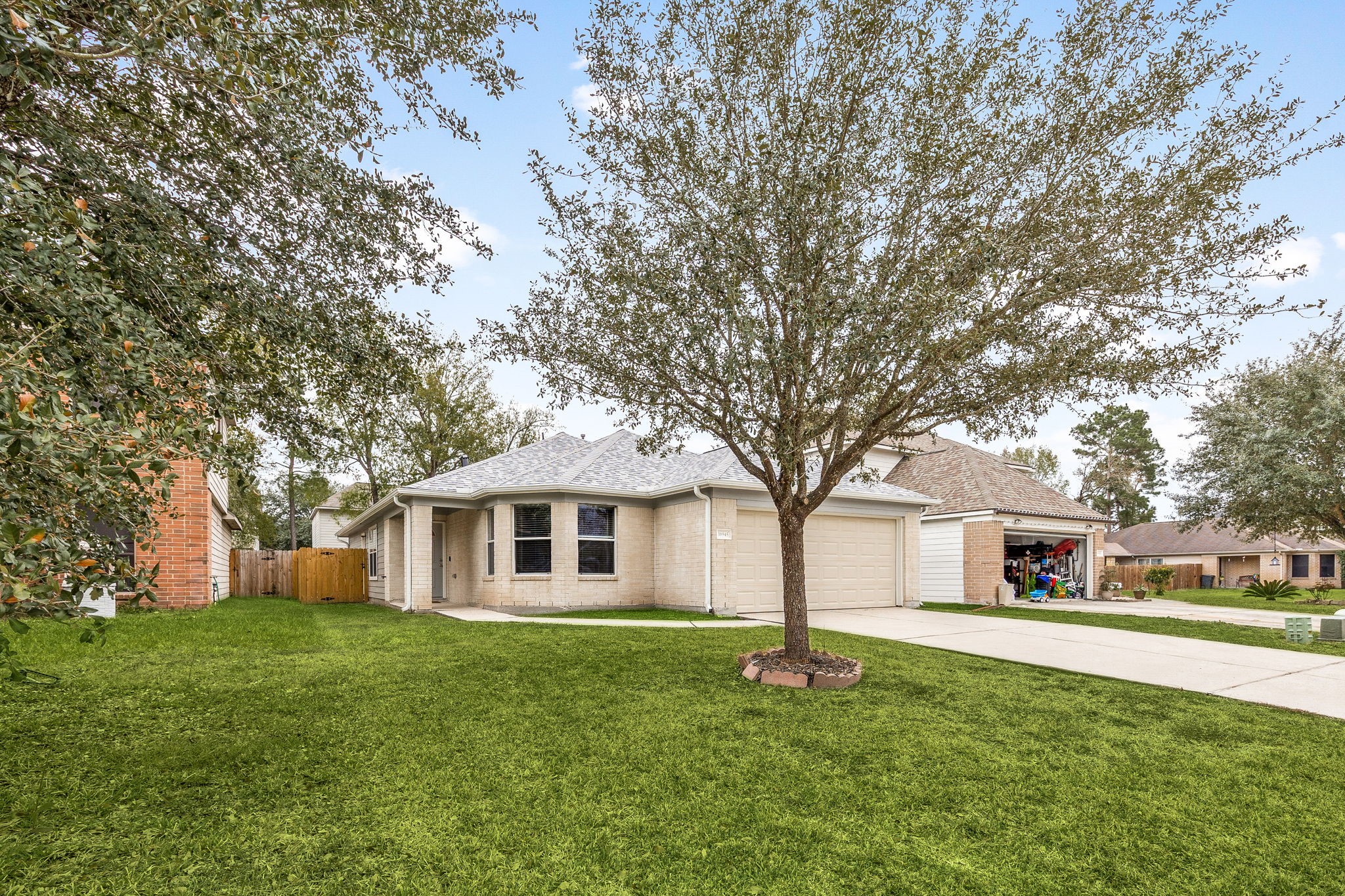 16945 Scenic Knoll Conroe, TX 77385 - Photo 4 of 39 a front view of a house with a garden